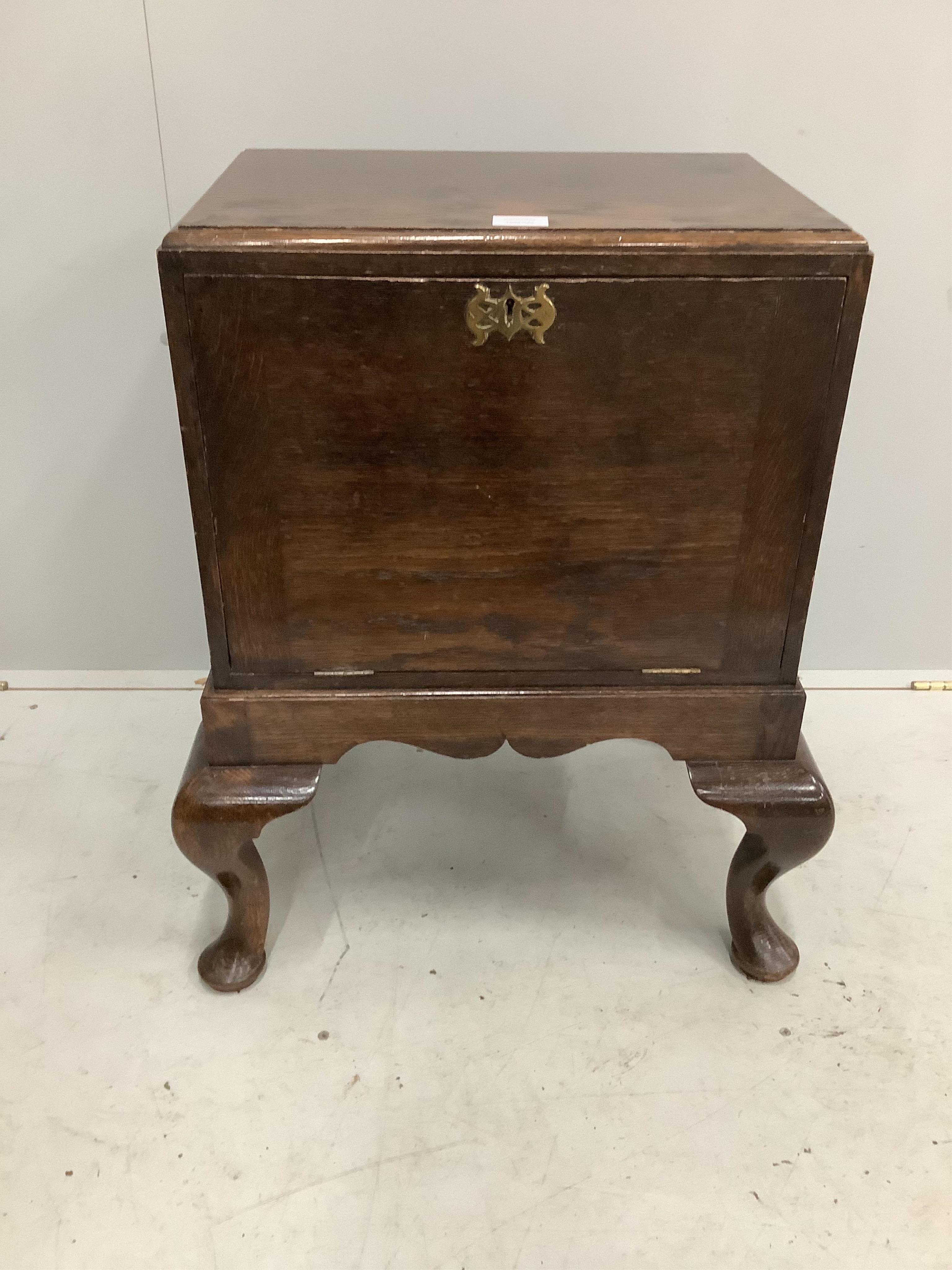 An early 20th century George II style oak record cabinet on cabriole legs, width 59cm, depth 45cm, height 71cm. Condition - fair